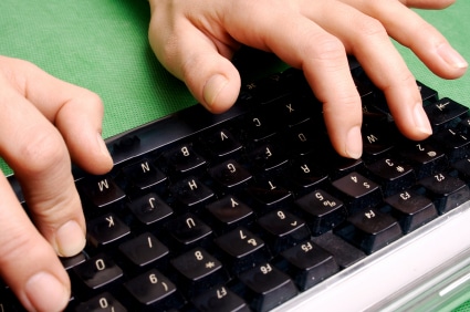 Fingers typing on keyboard