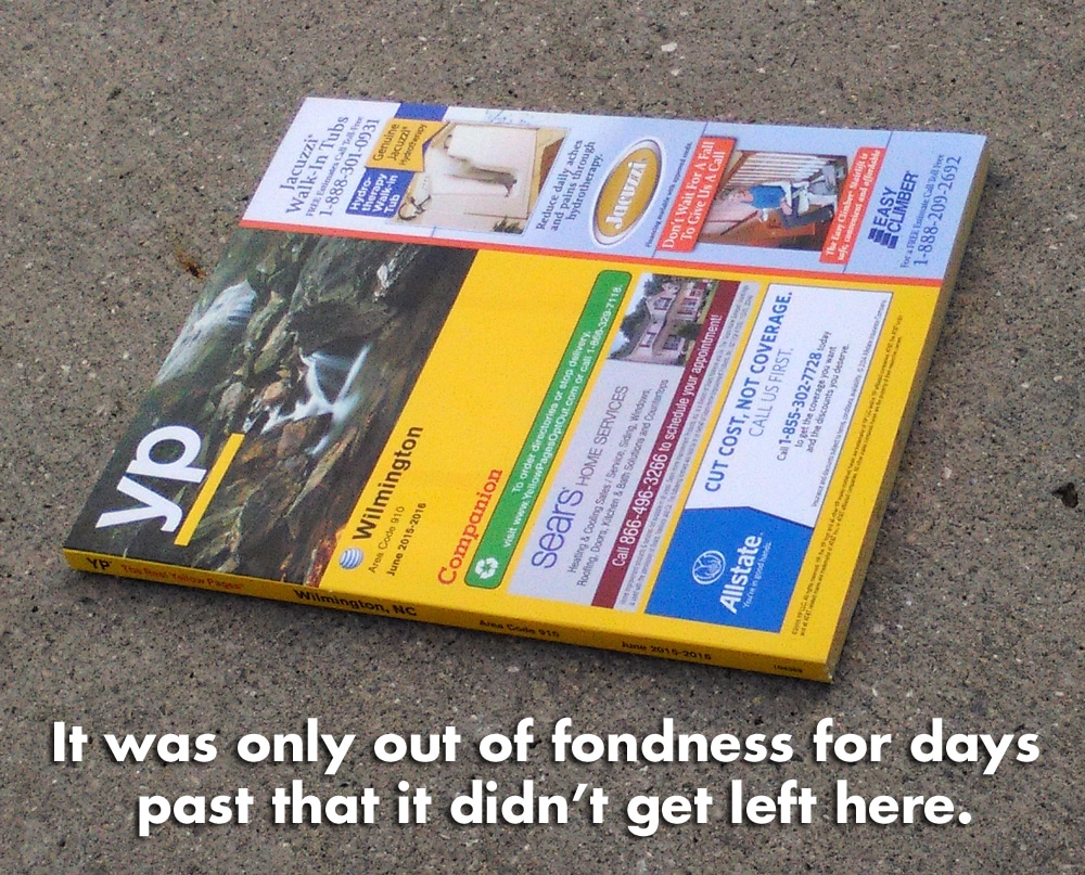 Yellow pages book on ground